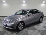 the mercedes c - class is parked on a checkered floor