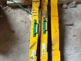 two yellow skis sitting on the floor in the garage