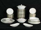 a lot of plates and bowls on a black background