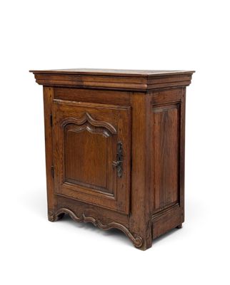 an old wooden cabinet with a door and a drawer underneath it