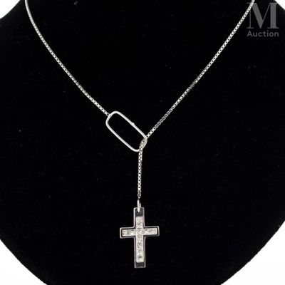 a close up of a necklace with a cross on a mannequin