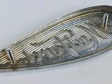 an image of a close up of a metal object on a white surface