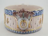 a close up of a white and blue bracelet with a clock on it
