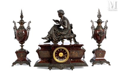 a statue of a woman sitting on a table next to three vases and a clock