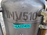 a close up of a metal tank with a hose attached to it