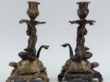 pair of bronze candlesticks with figures on turtle bases