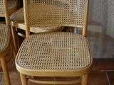 four chairs sitting next to each other on a brick floor