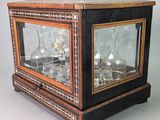 a glass case with a clock inside of it on a table