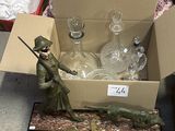 a box full of glass bottles and a statue of a soldier