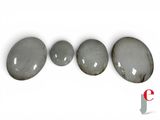 three gray stones sitting next to each other on top of a white surface