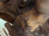 a close up of a statue of a man holding a bird