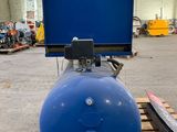 an image of a blue tank sitting on top of a wooden pallet