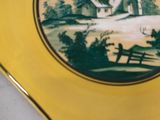 a yellow plate with a picture of a house on it
