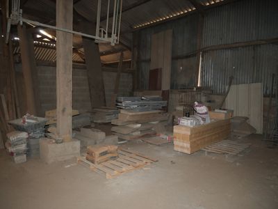 a room that has a lot of boxes and pallets on the floor