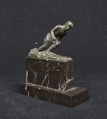 bronze statue of a man on a marble base