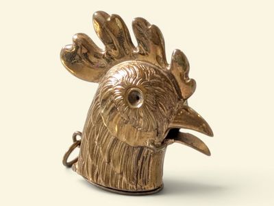 a gold statue of a rooster on a white background