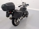 a motorcycle that is parked in a room with white walls