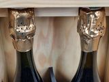two bottles of wine that are in a wooden box