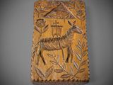 a wooden plaque with a deer and leaves on it