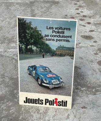 a poster of a blue sports car on the pavement