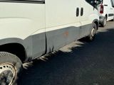 a white van that is parked on the side of the road