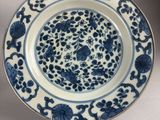 a blue and white plate with flowers on it