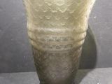 a glass vase that is sitting on a table