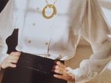 a woman in a white shirt and black skirt posing for a picture