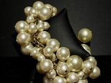 pearled bracelet on a mannequin stand with a black background
