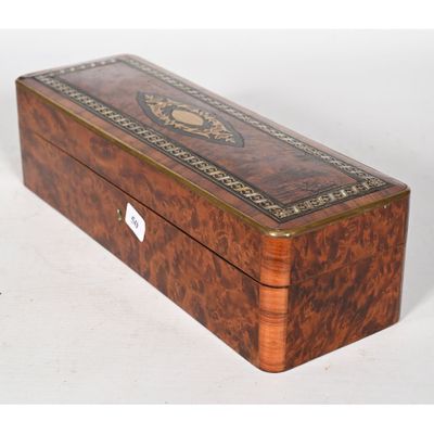an old wooden box with a decorative design on the lid