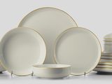 many plates and bowls that are stacked together
