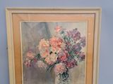 painting of flowers in a vase on a table in front of a blue wall