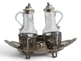 a silver plate with two silver vases on top of it