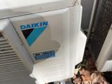 a white air conditioner with a blue sticker on it