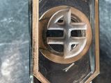 an image of a glass perfume bottle with a cross on it