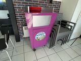 a pink refrigerator in the corner of a room