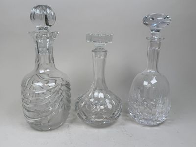 three clear glass bottles sitting next to each other on a white surface