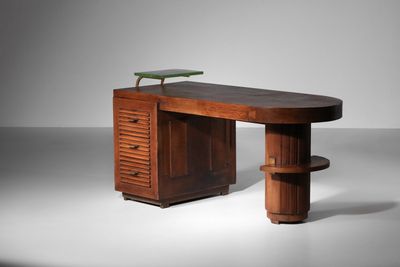 an image of a wooden desk with a green plant on top