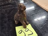 a small dog figurine sitting on a table next to a piece of paper