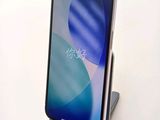the back view of a smartphone with a charging dock attached to it