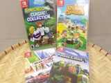 two nintendo wii games sitting on top of a basket on top of a table