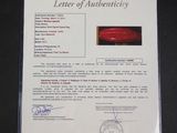 certificate of authenticity of a red car in a black background
