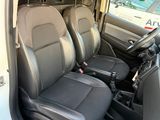 the interior of a white van with two black seats and a steering wheel