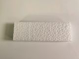 a close up of a piece of paper on a white surface