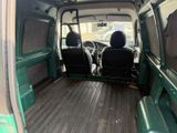 two seats in the back of a green van