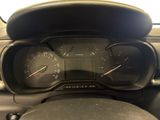 a close up of a dashboard with a speedometer and a steering wheel