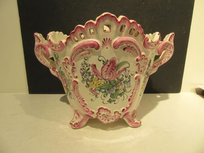 a pink and white bowl with a floral design on it