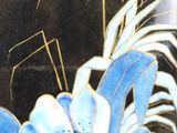 a black vase with blue flowers on it and a man in a suit