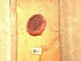 a red wax seal on the side of a building