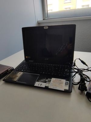 a laptop computer sitting on a table next to a hard drive
